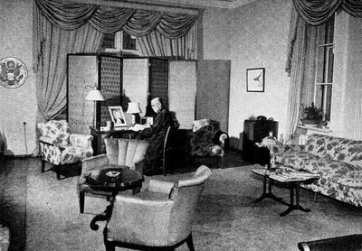 The Great Seal is visible to the left, on the office wall beyond the Ambassador’s desk.
